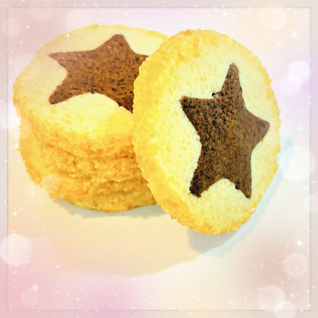 A small stack of vanilla sablé, the inside of the cookies with cute chocolate stars baked into them, and the outsides rolled in crunchy demerara sugar.