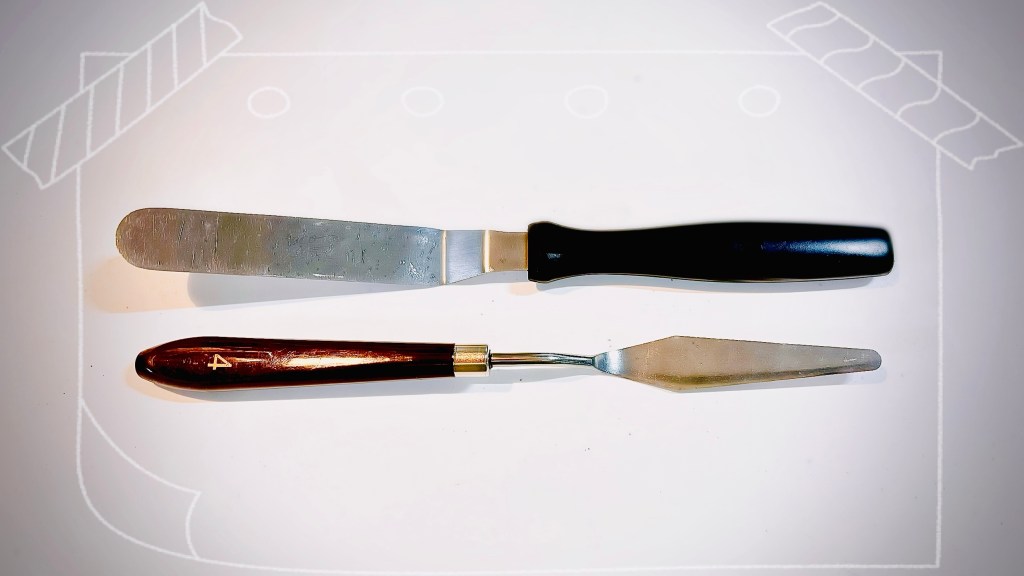 A small offset spatula for kitchens, with a painting pallet knife adapted for kitchen use beneath it.
