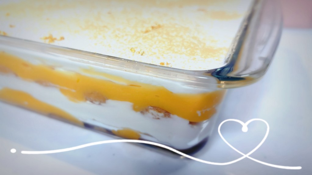A glass pan, used to show off the layers of browned ladyfingers, bright yellow lemon curd, and creamy mascarpone topping that was lemon tiramisu.