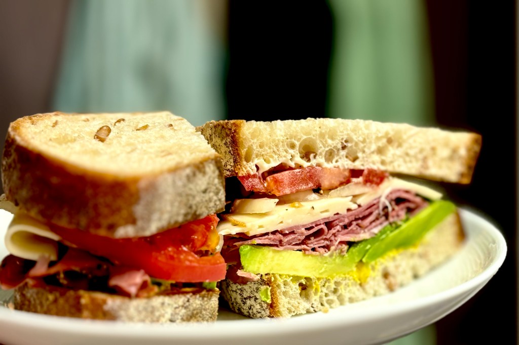 A very well-made sandwich, which is a hard thing to find in Japan. This one is cut to show off its layers of pastrami, Swiss cheese, perfectly ripe slices of tomato and avocado, as well as mayo and mustard.